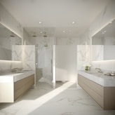 a large bathroom with marble counter tops and sinks