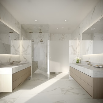 a large bathroom with marble counter tops and sinks