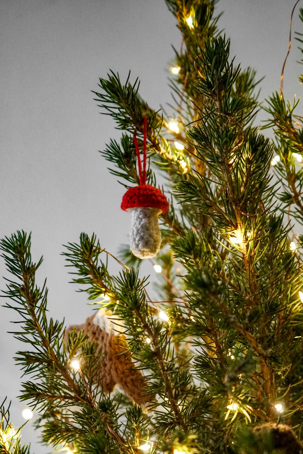 a close up of a christmas tree with ornaments on it