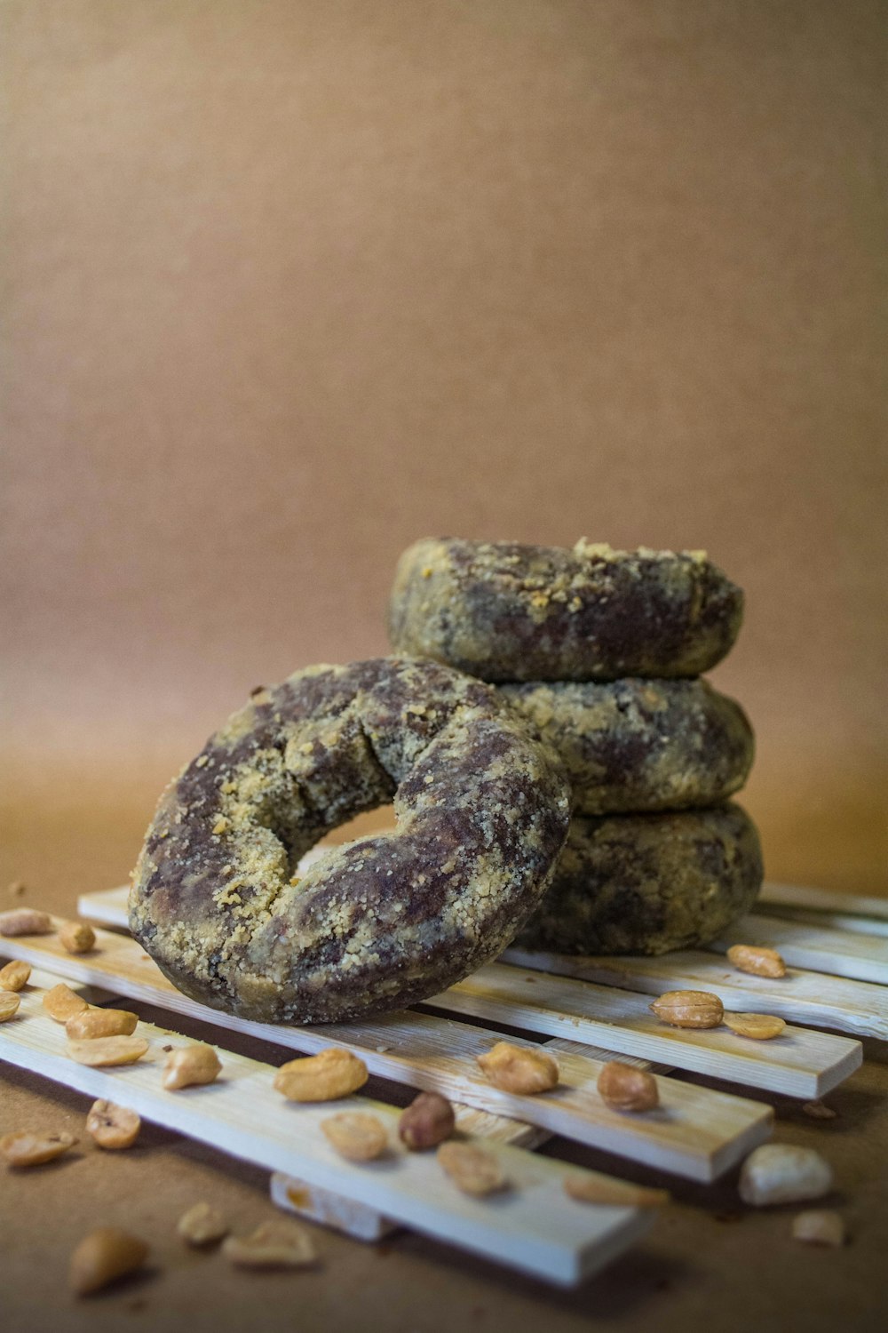 a pile of doughnuts sitting on top of a wooden table