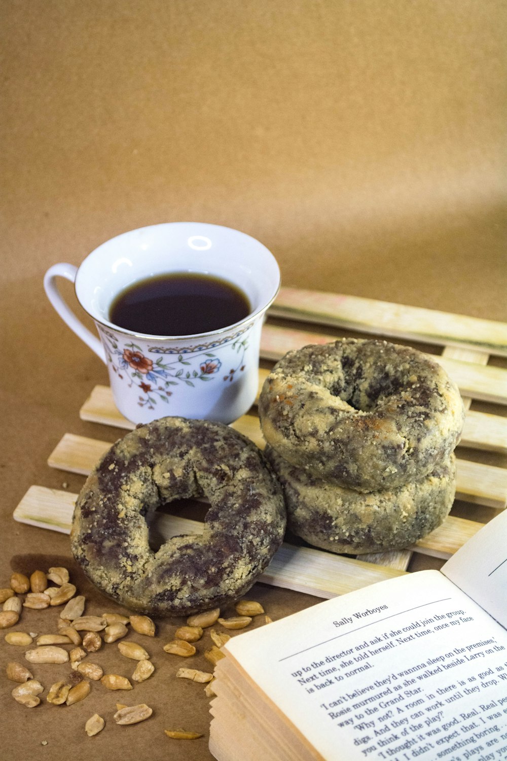 a couple of doughnuts sitting next to a cup of coffee