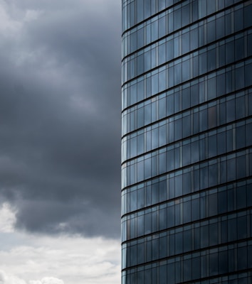 a very tall building with a very cloudy sky in the background