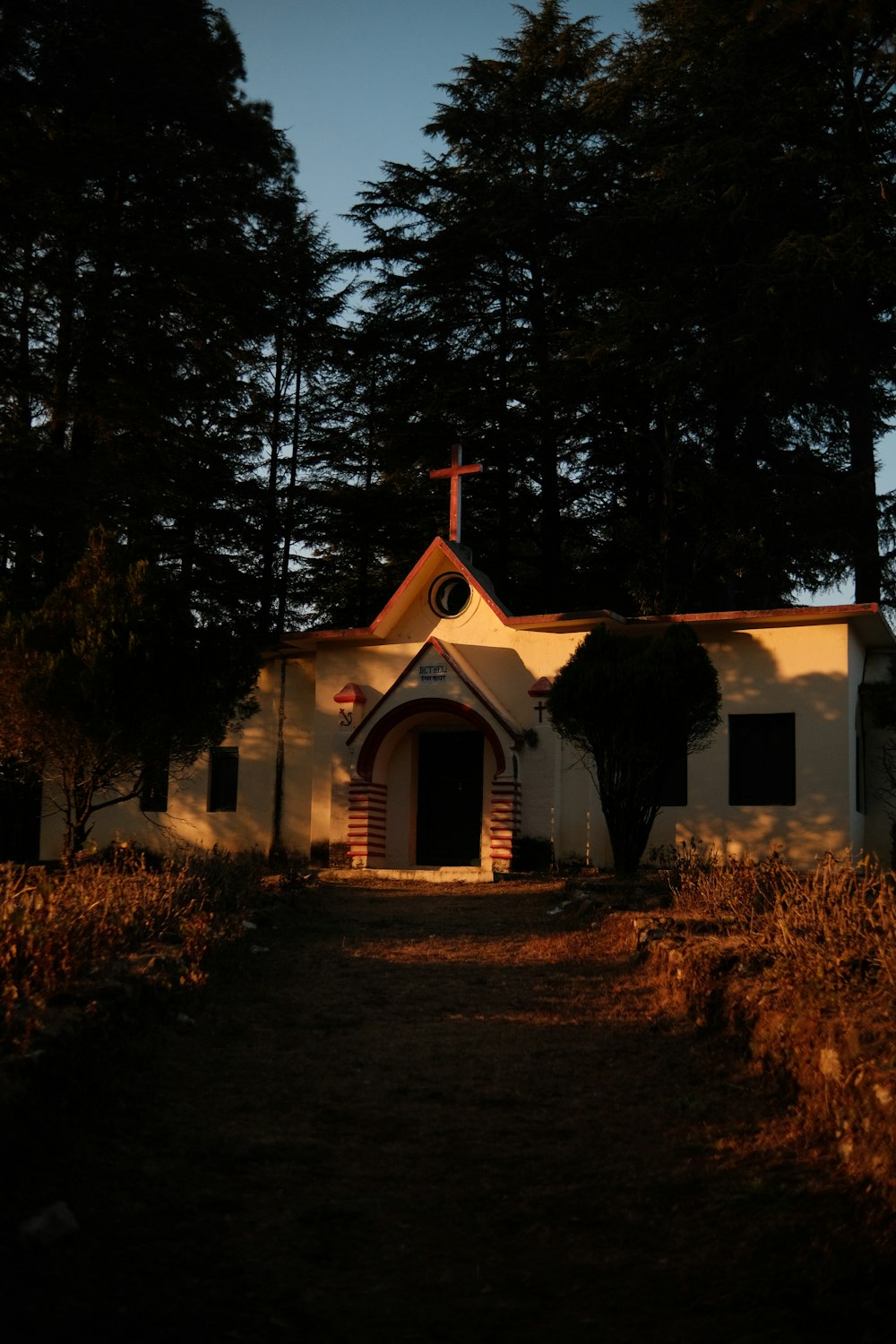 a small church with a cross on top of it