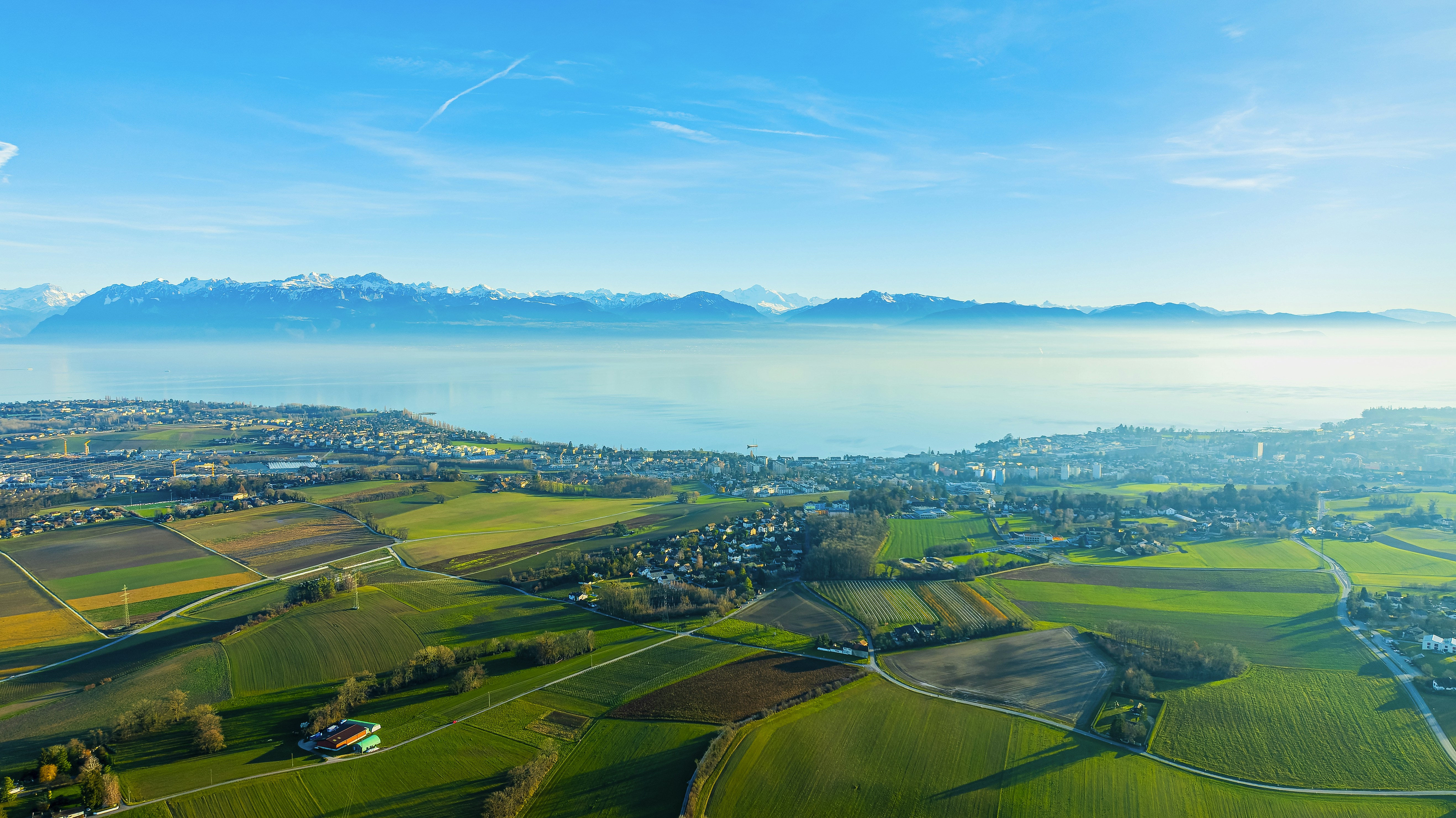 an aerial view of a town and a body of water