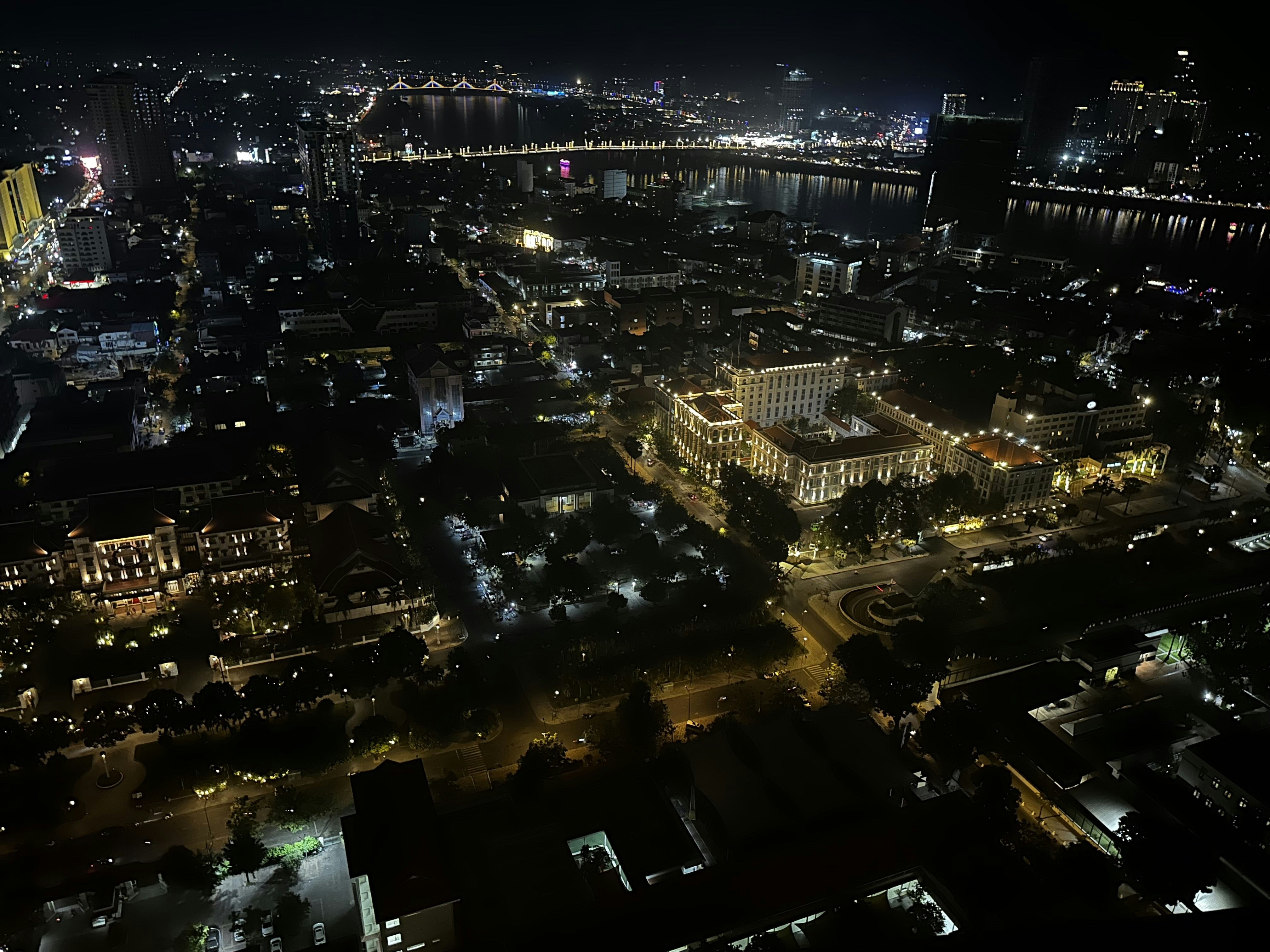 Aerial view of illuminated bridge and river at night