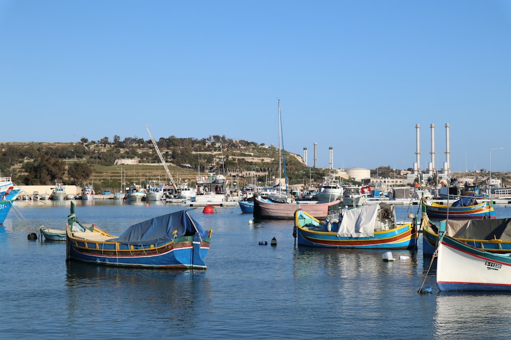 a group of boats floating on top of a body of water