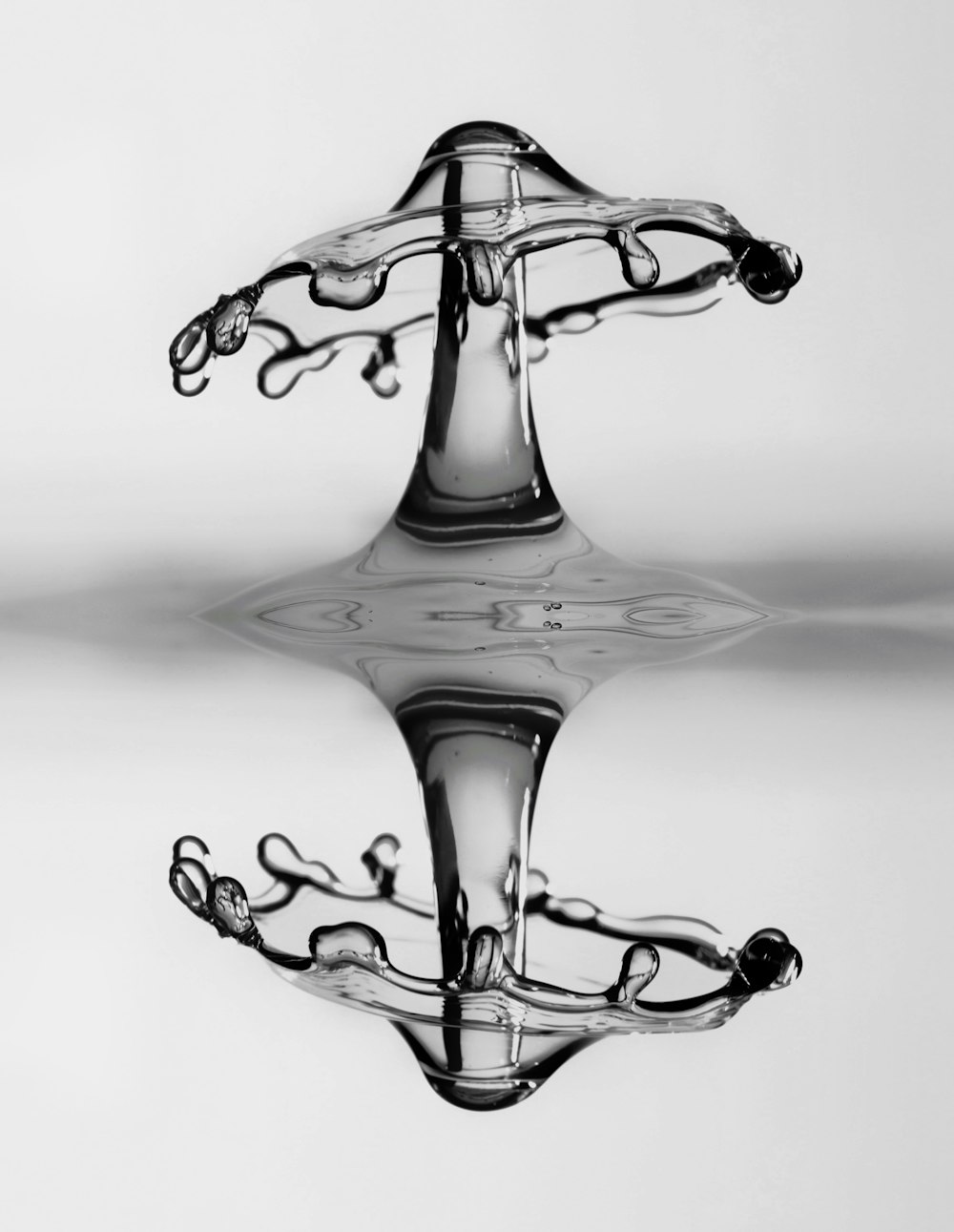 a black and white photo of a water drop