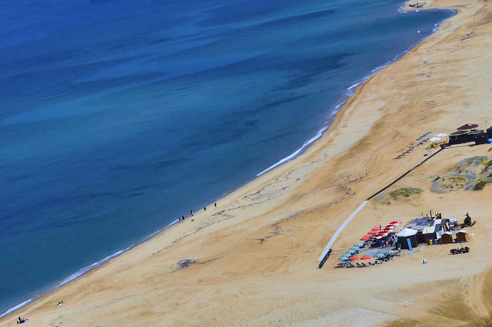 an aerial view of a sandy beach and a body of water