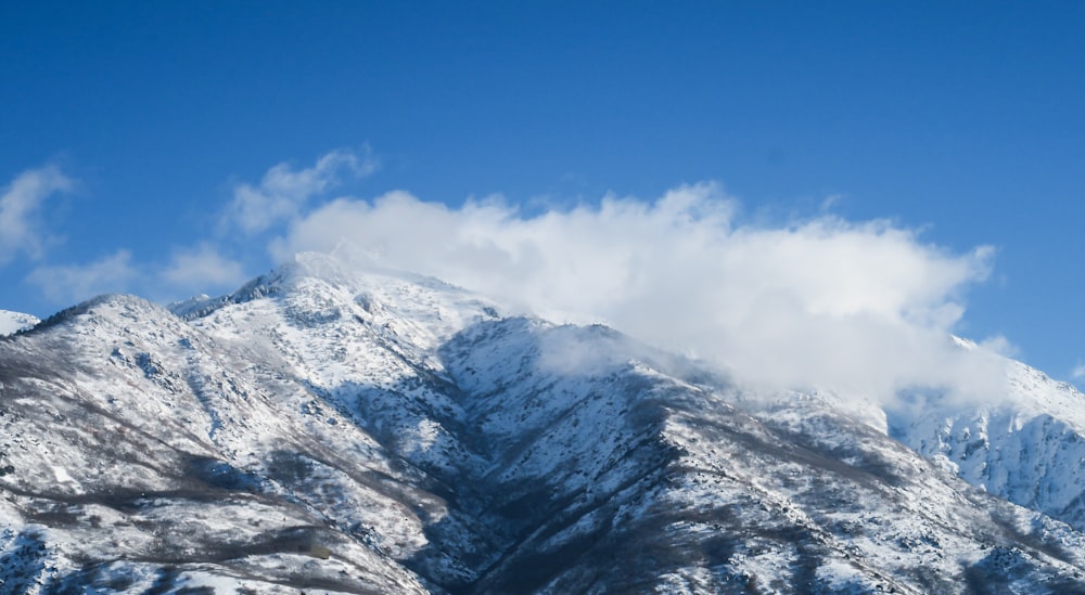 a mountain covered in snow under a blue sky