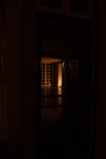 an open door in a dark room at night