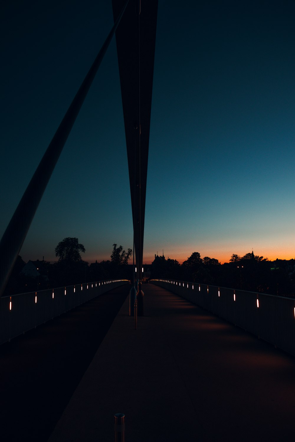 a long walkway with lights on it at night