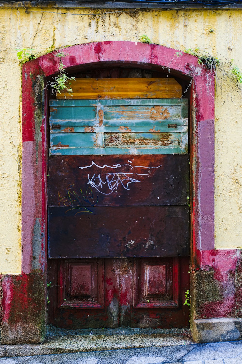 an old door with graffiti on the side of it