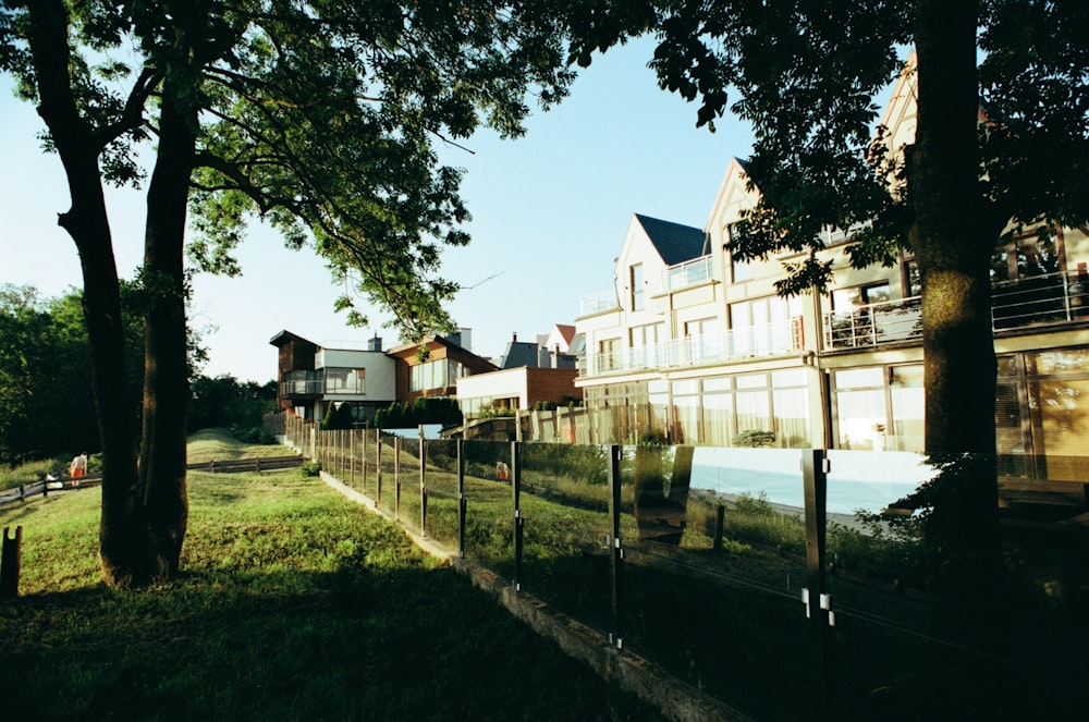 a row of houses next to a fence and trees