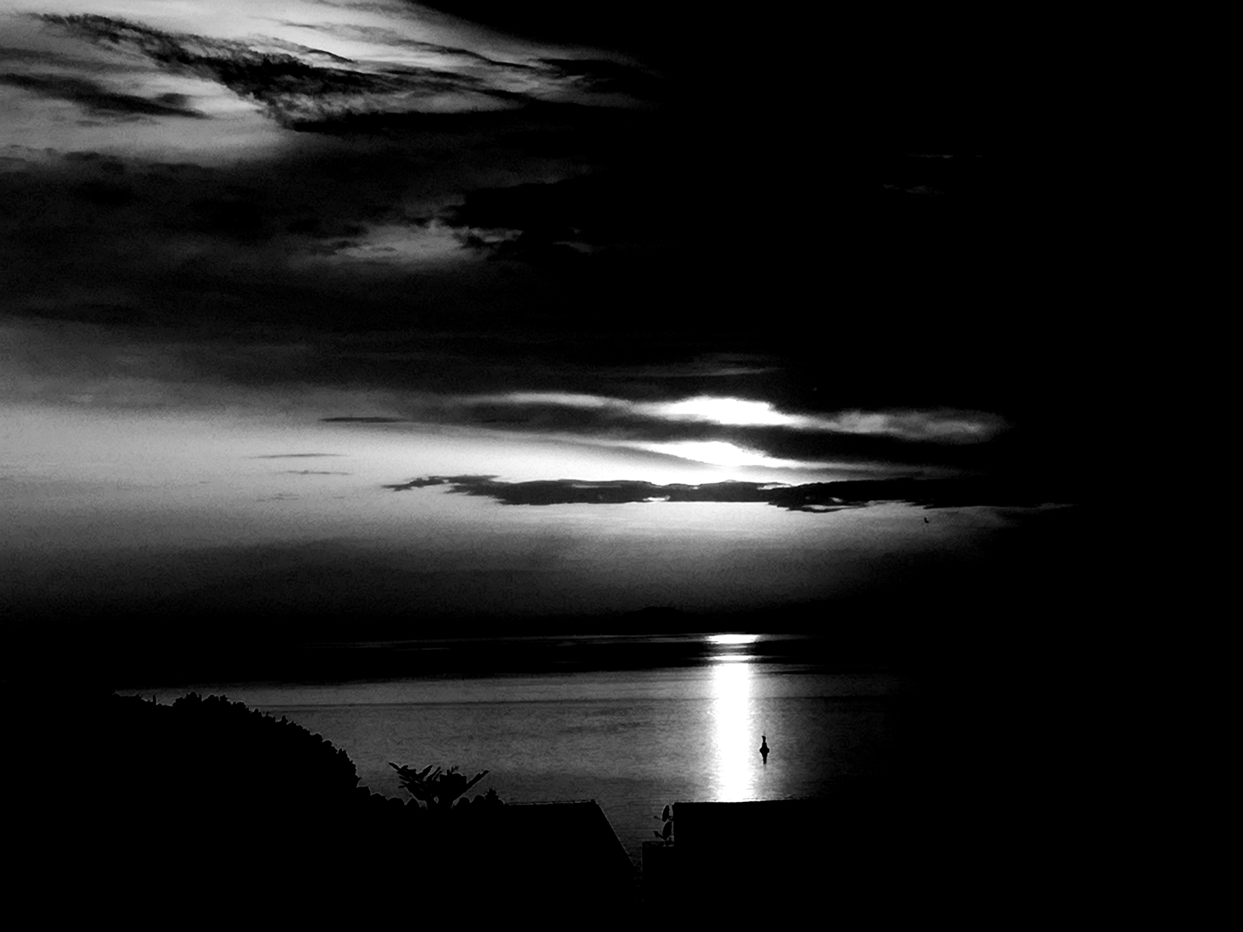 Calm water surface with dramatic reflection of dim sky, cinematic moody tone, dark and atmospheric