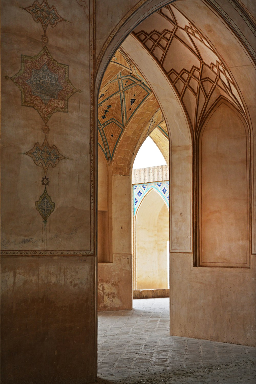 an archway in a building with a painting on the wall