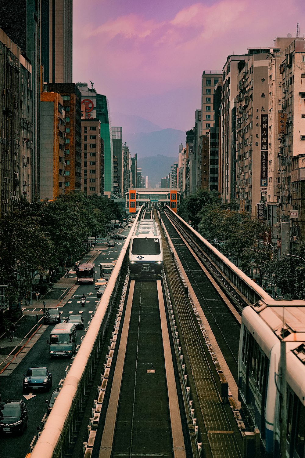 a train traveling down train tracks next to tall buildings