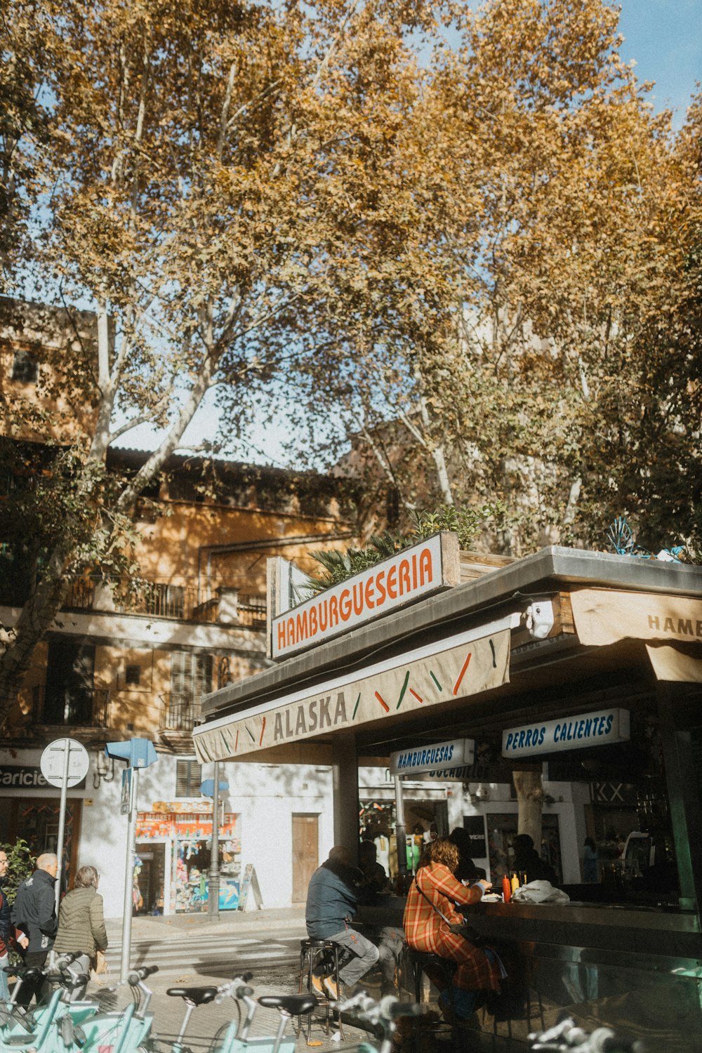 a group of people sitting at a table in front of a building