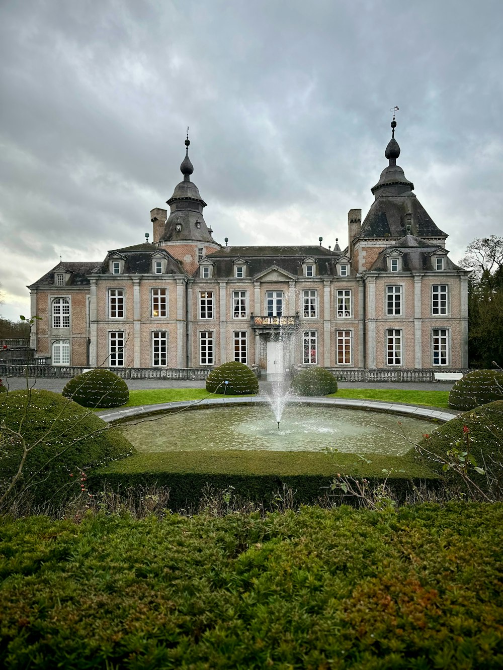 a large building with a fountain in front of it