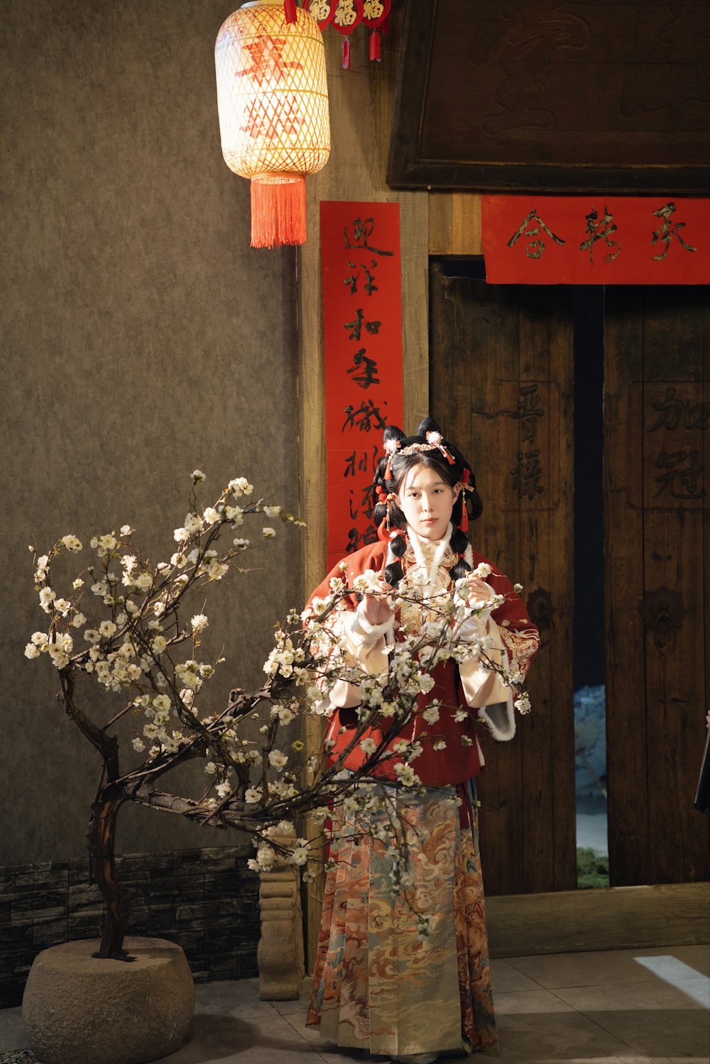 a woman in a kimono holding a bouquet of flowers