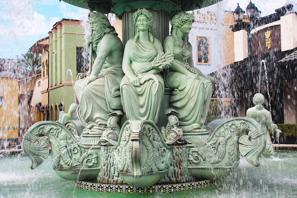 a fountain with a statue of a woman sitting on top of it