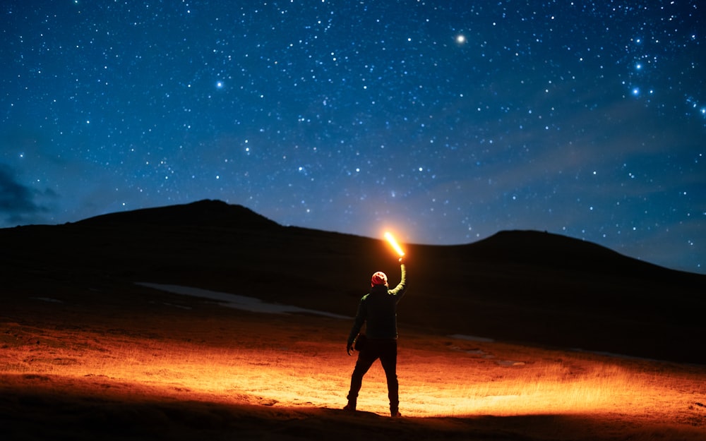 a man holding a light up in the air