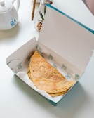 an open box of food sitting on a table