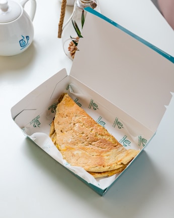 an open box of food sitting on a table