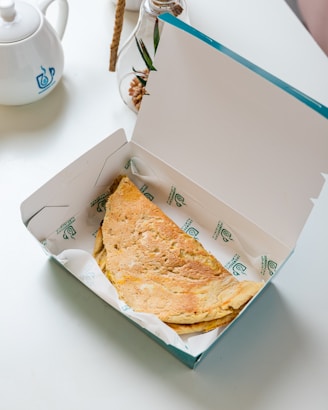 an open box of food sitting on a table