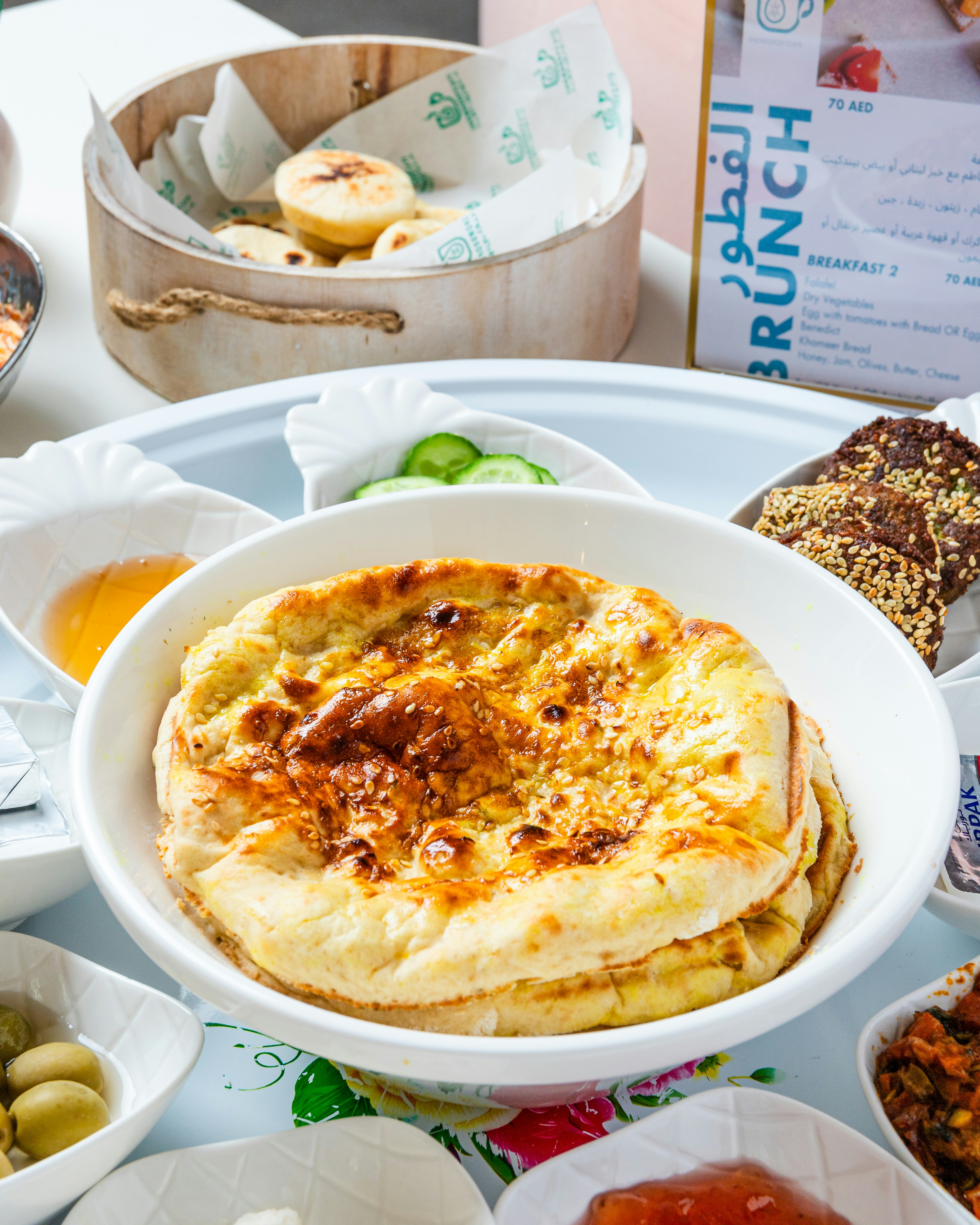 Desenli bir masada servis edilen çeşitli kahvaltı tabakları.
