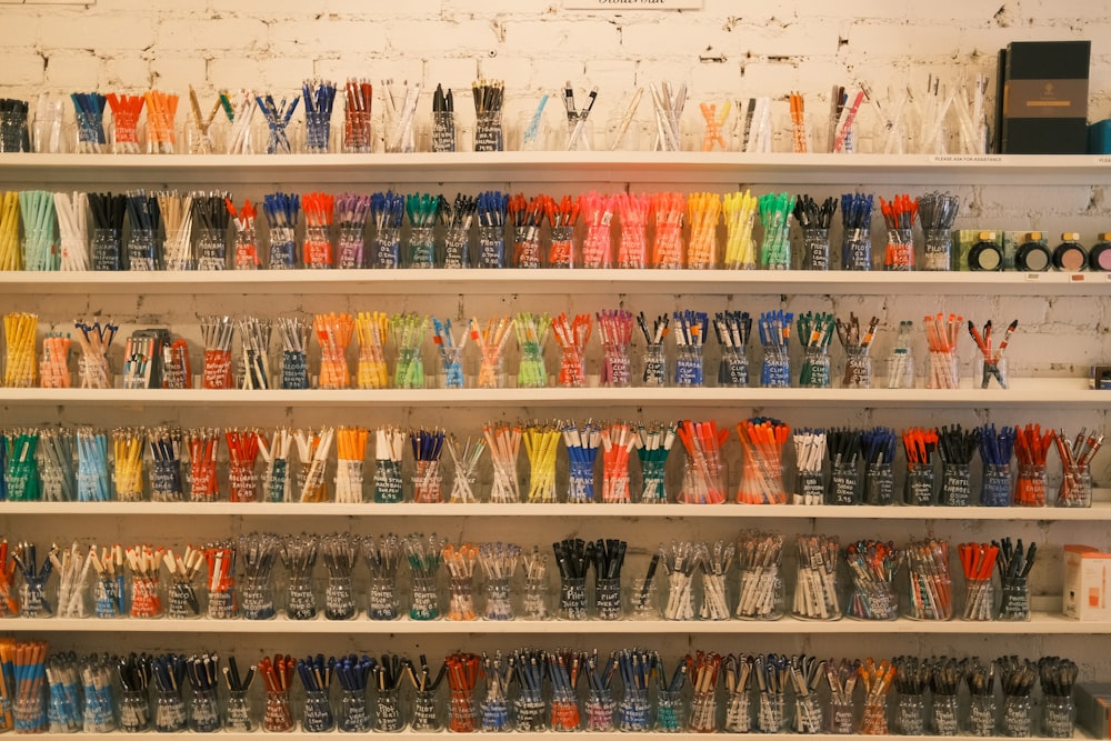 a shelf filled with lots of different colored toothbrushes