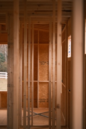 Interior of a home under construction showing wood framing and unfinished walls before drywall installation