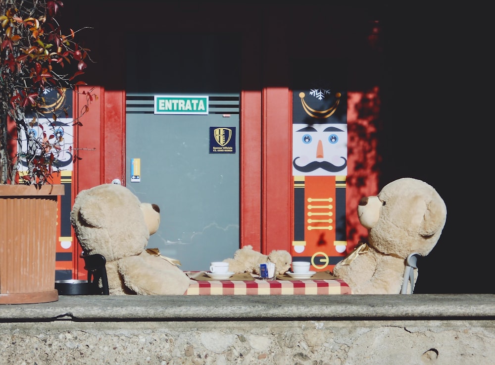 a couple of teddy bears sitting at a table