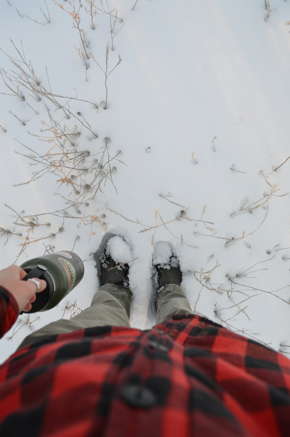 a person standing in the snow with their feet in the snow