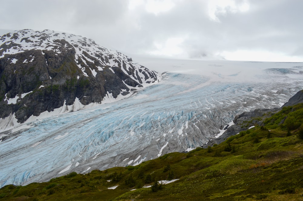 a large glacier with a mountain in the background