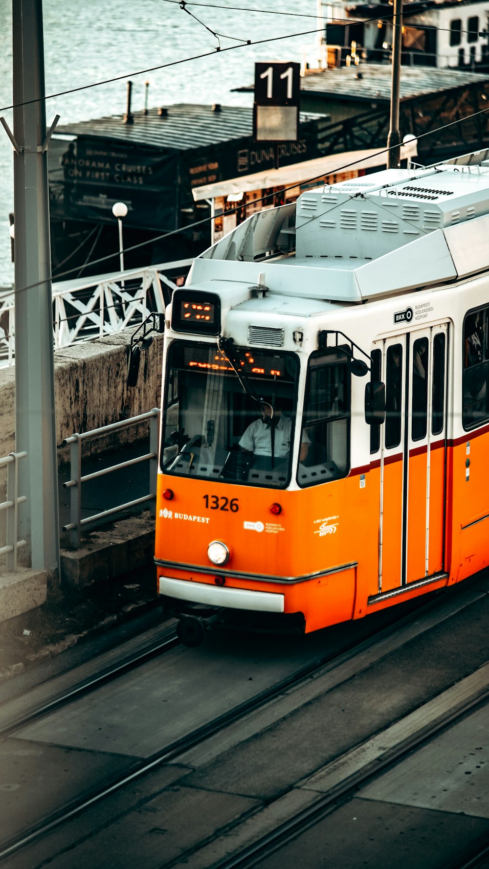 an orange and white train traveling down train tracks