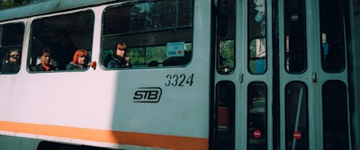 a group of people riding on the back of a bus