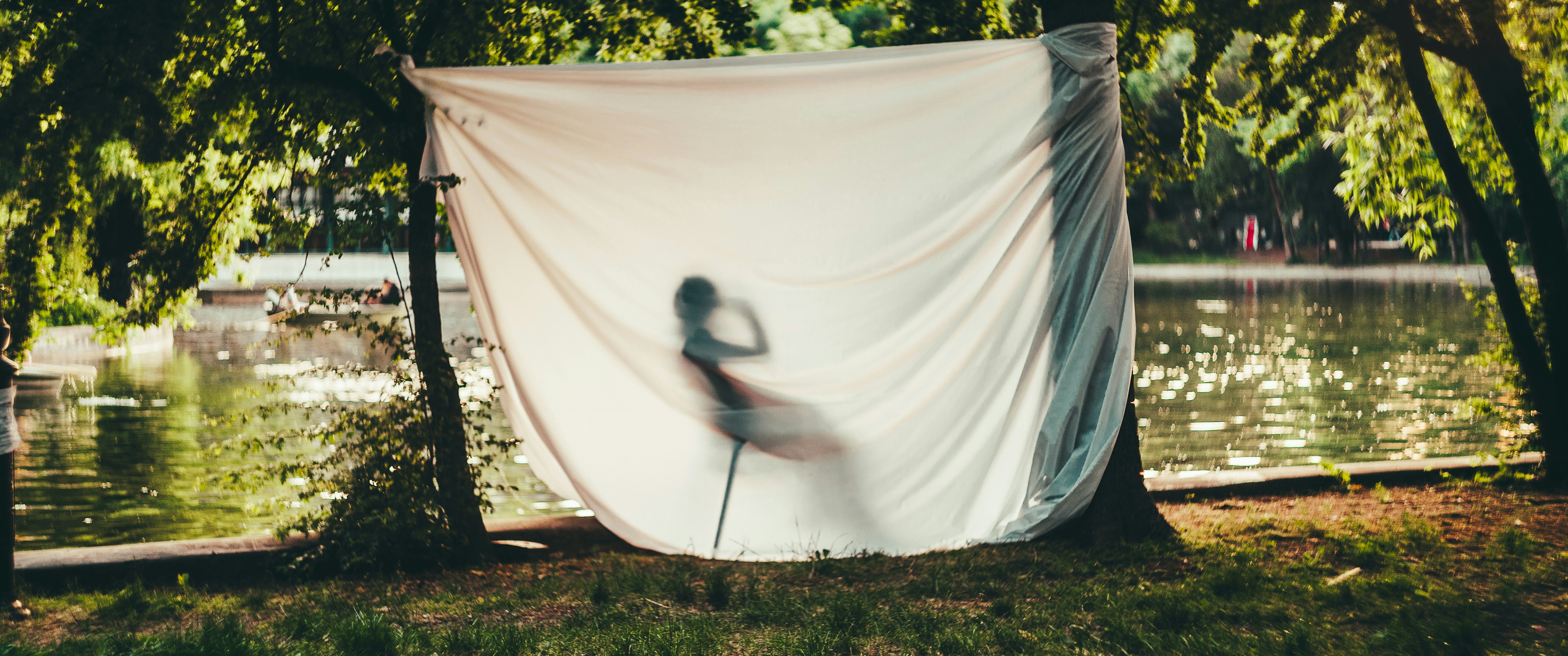 a woman standing in front of a white sheet