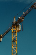a yellow crane with a blue sky in the background