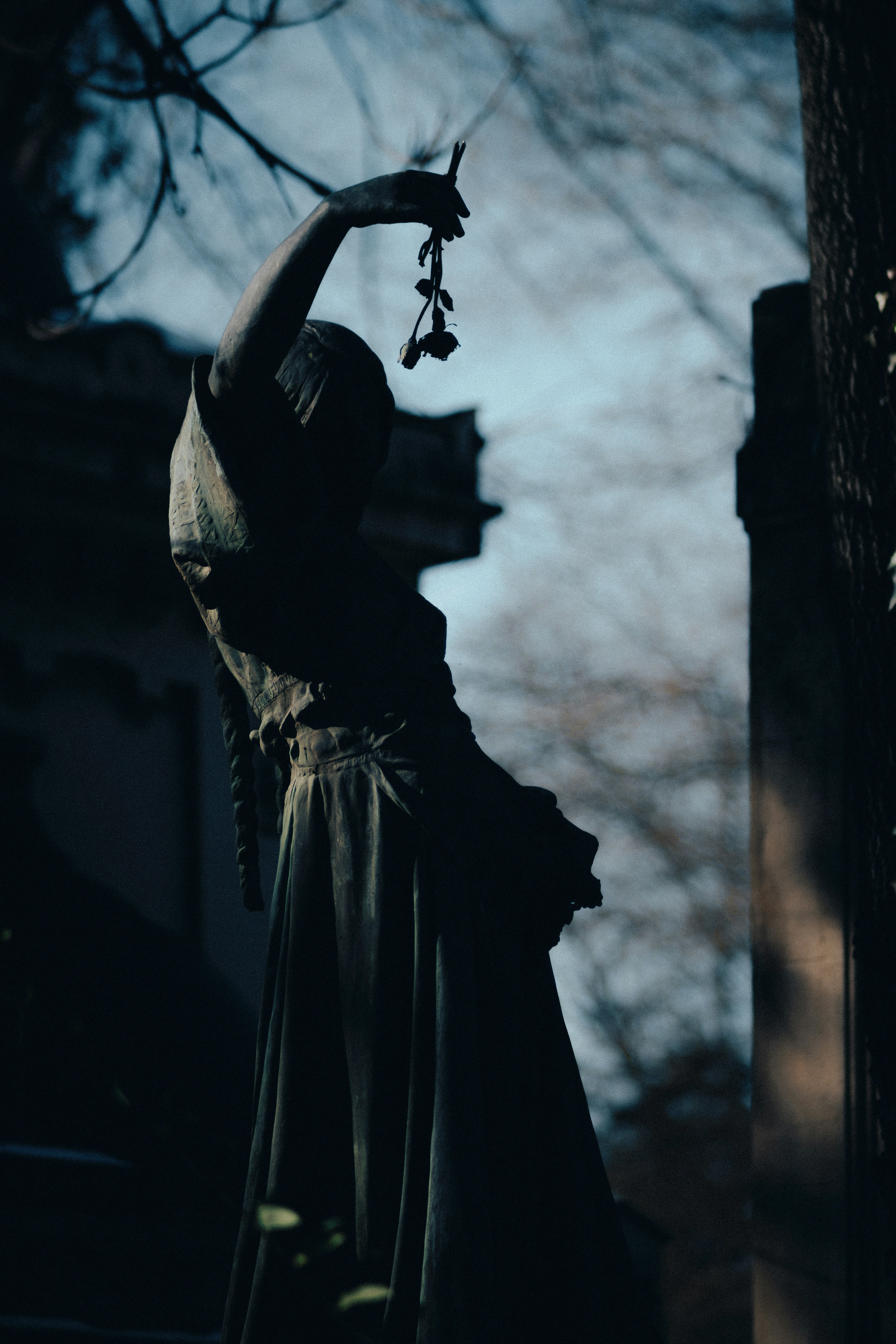 a statue of a woman with a flower in her hand