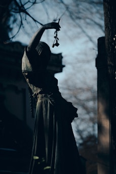 a statue of a woman with a flower in her hand