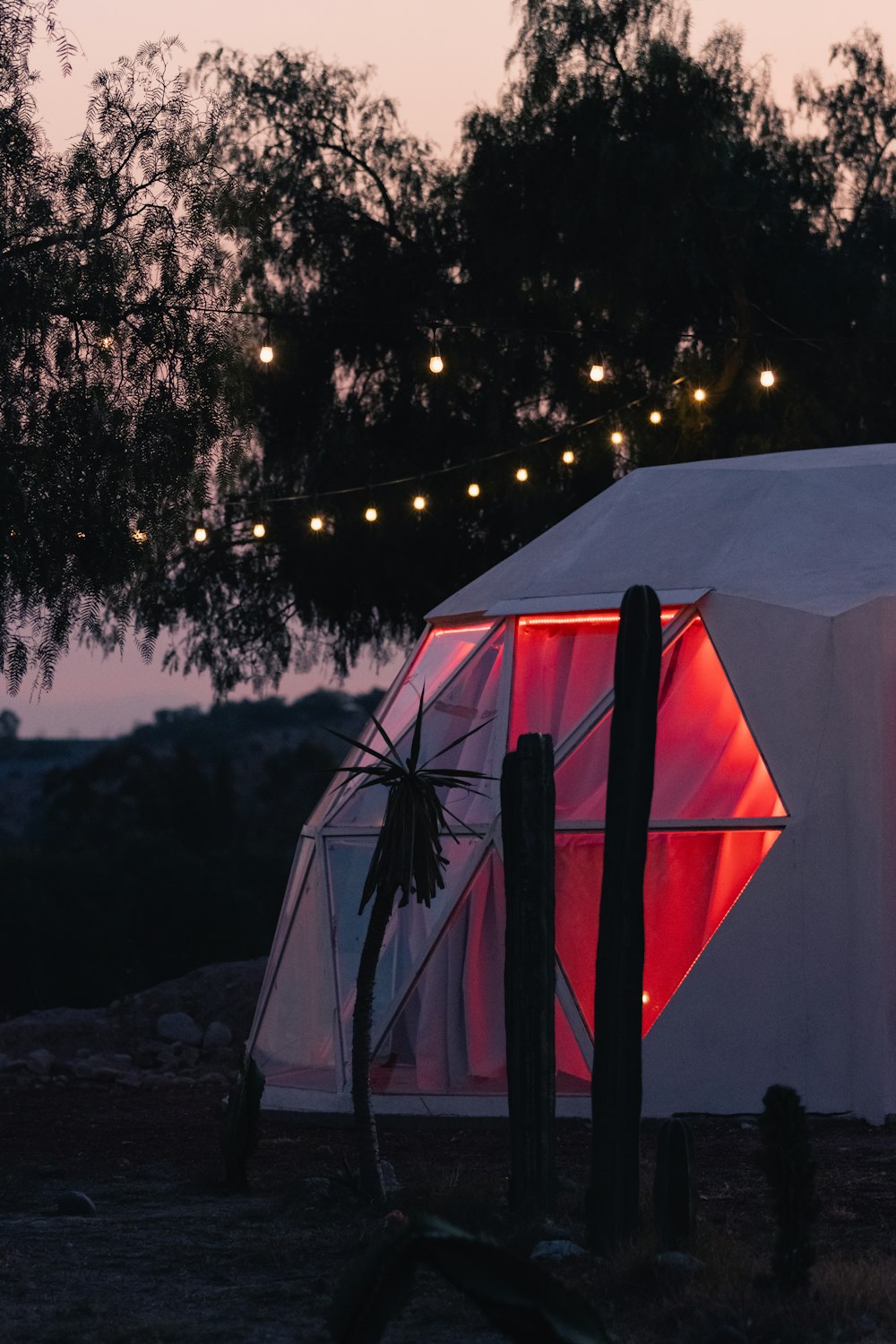 a white tent with a red light inside of it