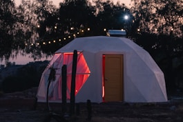 a small white building with a red door