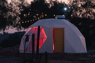 a small white building with a red door