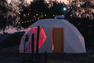 a small white building with a red door