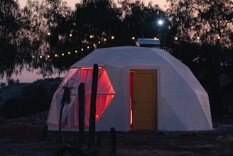 a small white building with a red door