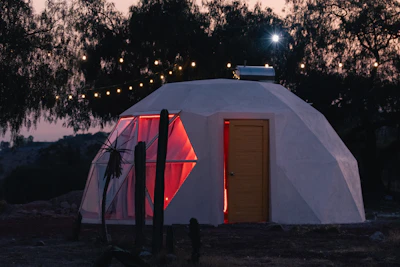 a small white building with a red door