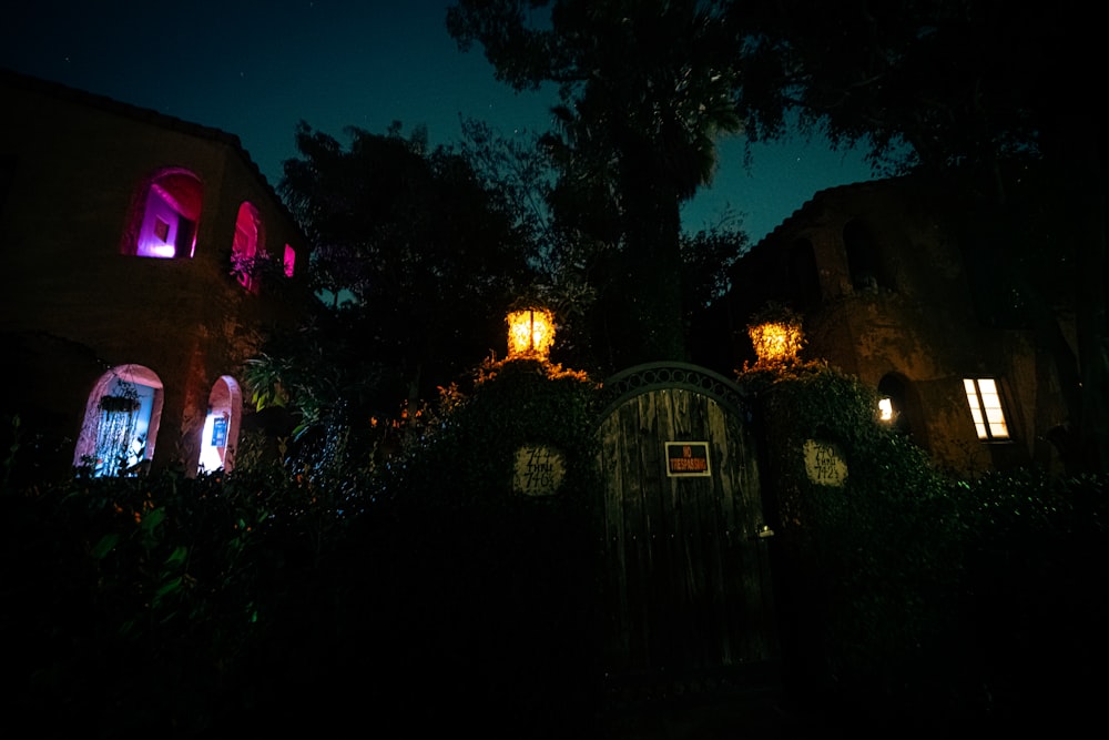 a house is lit up at night with colorful lights