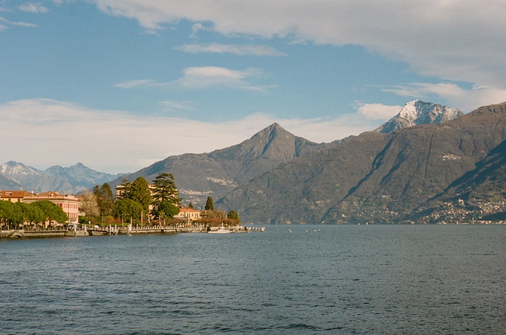 a body of water with mountains in the background