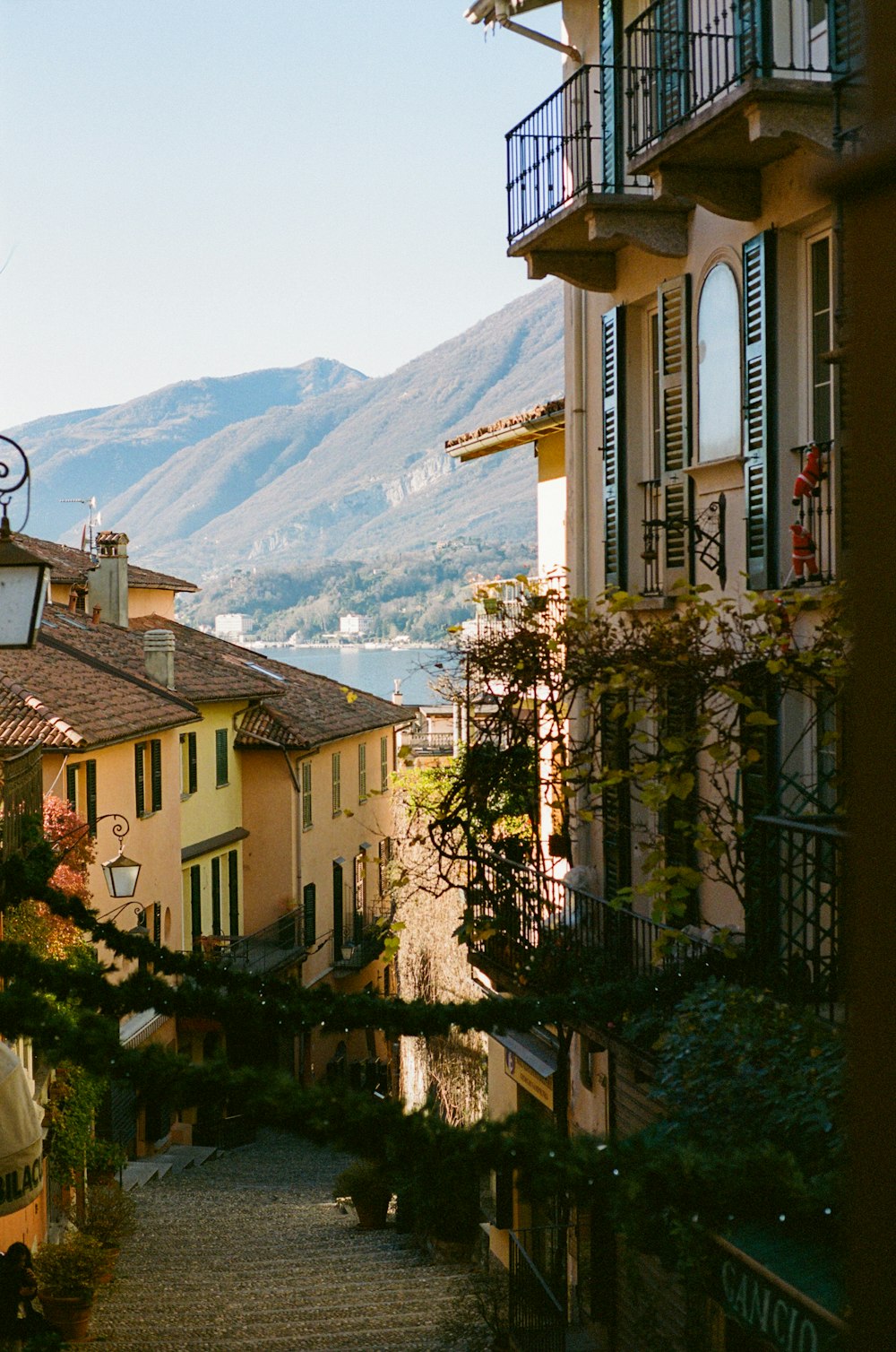 a view of a street in a small town with mountains in the background