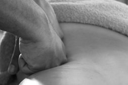 a man getting a back massage from a massager